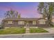 Charming brick home with well-manicured lawn and a lovely glass-accented front door at 3150 W Stanford Ave, Englewood, CO 80110