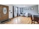 Living room with hardwood floors, grey walls, a decorative wall and a view of the front door at 3150 W Stanford Ave, Englewood, CO 80110