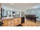 Open living space with a large kitchen island flowing into the dining and living areas at 3150 W Stanford Ave, Englewood, CO 80110