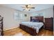 Bedroom with hardwood floors, a dark wood bed with storage, and natural light from the windows at 3150 W Stanford Ave, Englewood, CO 80110
