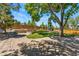 Landscaped backyard featuring a stone patio, lush lawn, garden beds, mature trees, and a charming swing at 1774 Brookside Dr, Highlands Ranch, CO 80126