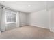 Finished basement featuring neutral carpeting, white trim, and a window for natural light at 1774 Brookside Dr, Highlands Ranch, CO 80126