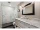 Updated bathroom with glass shower, marble countertops and modern fixtures at 1774 Brookside Dr, Highlands Ranch, CO 80126