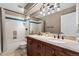 Bathroom featuring tiled walls, a tiled shower/tub combo, granite countertops, and double sinks at 1774 Brookside Dr, Highlands Ranch, CO 80126