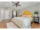 Bright bedroom featuring hardwood floors, ceiling fan and view to attached bathroom at 1774 Brookside Dr, Highlands Ranch, CO 80126