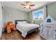 Cozy bedroom with hardwood floors, ceiling fan and plush bed perfect for relaxation at 1774 Brookside Dr, Highlands Ranch, CO 80126
