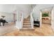 Grand entryway with high ceilings, tiled floors, and an open staircase with white railing at 1774 Brookside Dr, Highlands Ranch, CO 80126