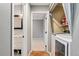 Hallway with laundry and bathroom featuring a view to another room at 1774 Brookside Dr, Highlands Ranch, CO 80126