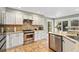 Well-equipped kitchen with white cabinets, granite countertops, and stainless steel appliances at 1774 Brookside Dr, Highlands Ranch, CO 80126