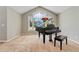 Well-lit living room featuring vaulted ceilings, grand piano, and large picture window at 1774 Brookside Dr, Highlands Ranch, CO 80126