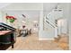 Open concept floorplan with stairs to upper level, adjacent to piano and dining area at 1774 Brookside Dr, Highlands Ranch, CO 80126