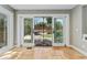 Bright sunroom featuring neutral paint, stone floors, and sliding glass doors leading to a landscaped yard at 1774 Brookside Dr, Highlands Ranch, CO 80126