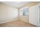 Simple carpeted bedroom with large window and neutral walls at 9876 W Freiburg Dr # G, Littleton, CO 80127