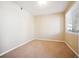 Simple carpeted bedroom with large window and neutral walls at 9876 W Freiburg Dr # G, Littleton, CO 80127