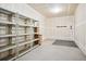 Unfinished garage with shelving and storage at 9876 W Freiburg Dr # G, Littleton, CO 80127