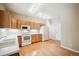 Kitchen boasts wood cabinets, white appliances, and hardwood floors at 9876 W Freiburg Dr # G, Littleton, CO 80127