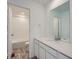 Bright bathroom featuring a modern vanity with a white countertop and a large mirror at 738 N Clubview St, Watkins, CO 80137