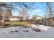 Fenced backyard with winter landscape with trees and a shed in a snowy environment at 11886 W 107Th Ave, Westminster, CO 80021