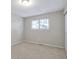 A bright, carpeted bedroom with a large window providing natural light and a closet at 11886 W 107Th Ave, Westminster, CO 80021