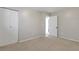 Neutral bedroom with carpeted flooring, white closet doors, and access to an adjoining bathroom at 11886 W 107Th Ave, Westminster, CO 80021