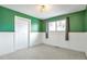 Green accent wall, wainscotting and plush carpet add charm to this cozy bedroom at 11886 W 107Th Ave, Westminster, CO 80021