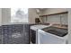 Laundry room with blue tile base and includes modern washer and dryer at 11886 W 107Th Ave, Westminster, CO 80021