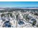 Aerial view of a snow-covered home nestled among trees, showcasing its mountain views at 9228 Lone Timber Ct, Parker, CO 80134