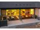 Inviting covered patio with fireplace, ample seating, and views of the backyard at 9228 Lone Timber Ct, Parker, CO 80134