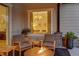 Charming outdoor patio with a fire pit and comfortable seating, offering a relaxing view into the bedroom at 9228 Lone Timber Ct, Parker, CO 80134
