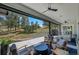 Expansive covered patio area with comfortable seating, fireplace, and serene views of the natural landscape at 9228 Lone Timber Ct, Parker, CO 80134