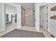 Modern bathroom featuring a glass-enclosed shower and access to the primary bedroom at 9228 Lone Timber Ct, Parker, CO 80134