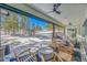 Relaxing covered patio with wood chairs overlooking a serene snow-covered landscape at 9228 Lone Timber Ct, Parker, CO 80134