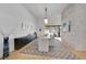 Elegant dining room with a stone accent wall, modern lighting and winter views at 9228 Lone Timber Ct, Parker, CO 80134