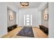 Inviting foyer with hardwood floors, featuring stylish benches and modern lighting at 9228 Lone Timber Ct, Parker, CO 80134