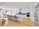 Modern white kitchen with stainless steel appliances, an island, and bar stool seating at 9228 Lone Timber Ct, Parker, CO 80134