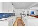 Spacious kitchen with white countertops, sleek white cabinets, and a blue tile backsplash for a modern touch at 9228 Lone Timber Ct, Parker, CO 80134