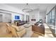 Spacious living room with a modern fireplace, hardwood floors, and ample natural light at 9228 Lone Timber Ct, Parker, CO 80134