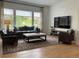 Comfortable living room with hardwood floors, plush seating, large windows, and plenty of natural light at 9228 Lone Timber Ct, Parker, CO 80134