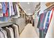 Large walk-in closet with custom shelving and drawers for organized storage at 9228 Lone Timber Ct, Parker, CO 80134