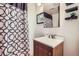 Bathroom featuring a single sink vanity and purple shower curtain and decor at 1958 Cathay Ct, Aurora, CO 80011