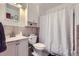 Functional bathroom featuring a vanity, toilet, and shower with a curtain at 1958 Cathay Ct, Aurora, CO 80011