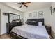 Cozy bedroom featuring a dark-colored bed frame, light-colored bedding, and decor at 1958 Cathay Ct, Aurora, CO 80011