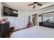 Bright bedroom features a large closet, mirrored dresser, and television at 1958 Cathay Ct, Aurora, CO 80011