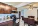 Bright kitchen features granite countertops, wood cabinets, and dining area at 1958 Cathay Ct, Aurora, CO 80011