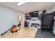 Spacious room with wood floors, tv, and workout equipment at 1958 Cathay Ct, Aurora, CO 80011
