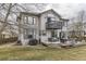 Large home featuring a spacious deck and patio area, a large grill, and mature landscaping at 10767 Appaloosa Ct, Parker, CO 80134