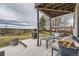 Relaxing backyard deck area with a fire pit, comfortable seating, and overhead string lights at 10767 Appaloosa Ct, Parker, CO 80134