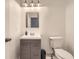 Modern bathroom features a gray vanity, square mirror, and new light fixture at 10767 Appaloosa Ct, Parker, CO 80134