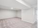 This finished basement features neutral colored carpet, walls, and ceiling with recessed lighting at 17634 E Ohio Cir, Aurora, CO 80017