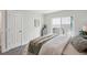 This bedroom features a door, window, bed and dresser with light walls and gray carpet at 17634 E Ohio Cir, Aurora, CO 80017